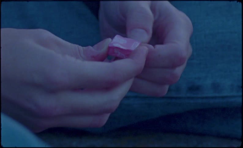 A person unwraps a piece of candy