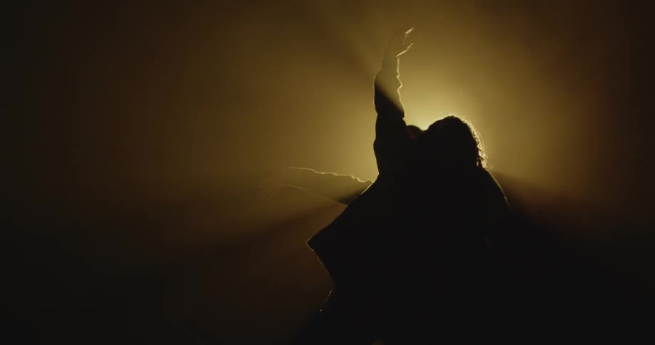 A man and woman dance under a spotlight