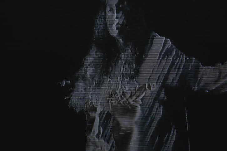 Silhouette of a woman dancing on vhs video distortion