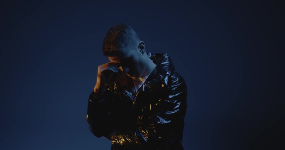 A sad and nervous man wearing a leather jacket