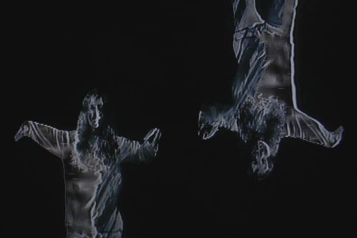 Mirror inverted image of a dancer against a black background