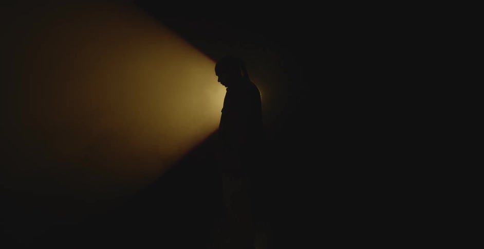 Silhouette of a man in front of a spotlight