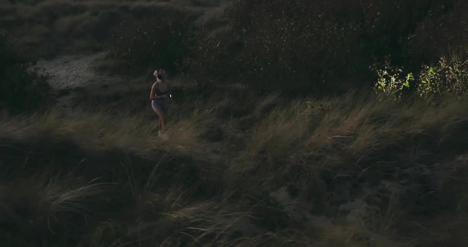 Woman uses a flashlight to search in the countryside