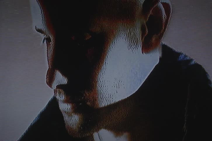 Close up of the face of a man with vhs video distortion