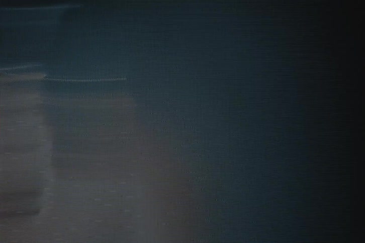 A woman is dancing under the lights and shadows