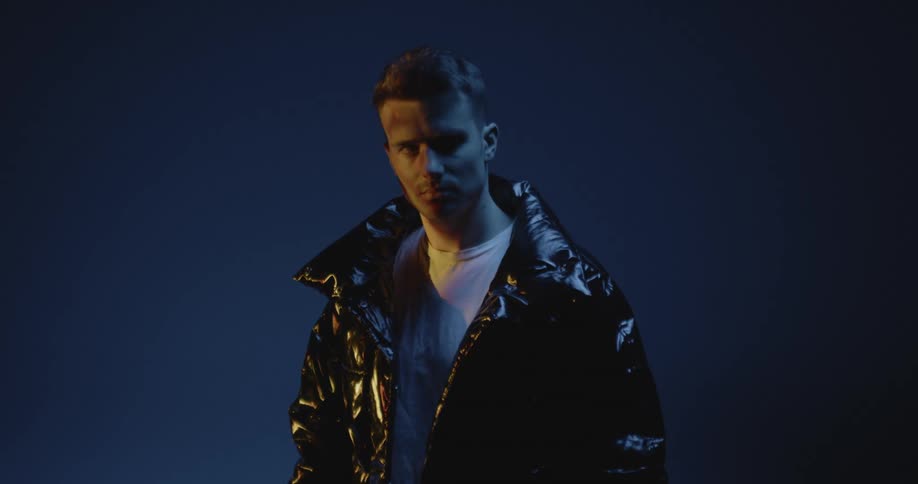 Young man models a jacket in the studio