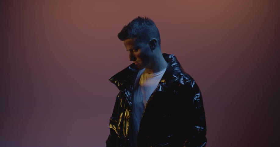 A man is looking down in the dark
