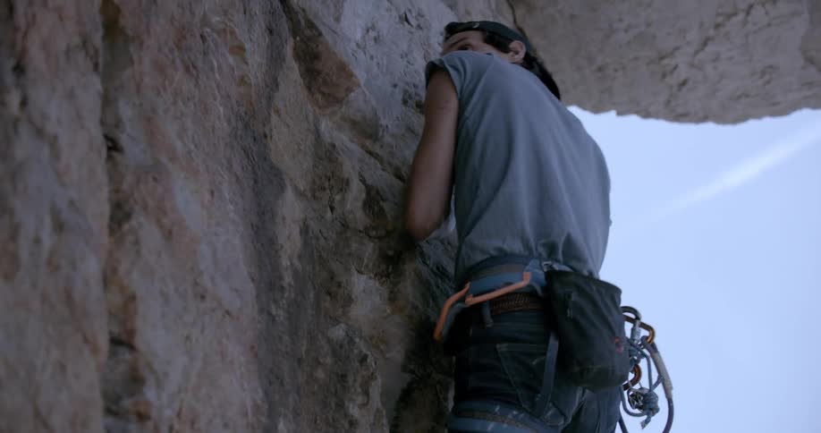Man climbs a rock wall in the cliffs