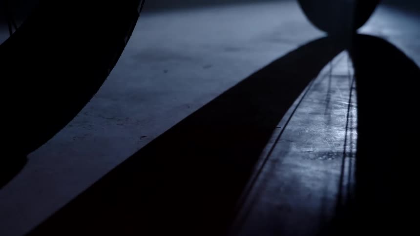 A shadow of a tire is in the room