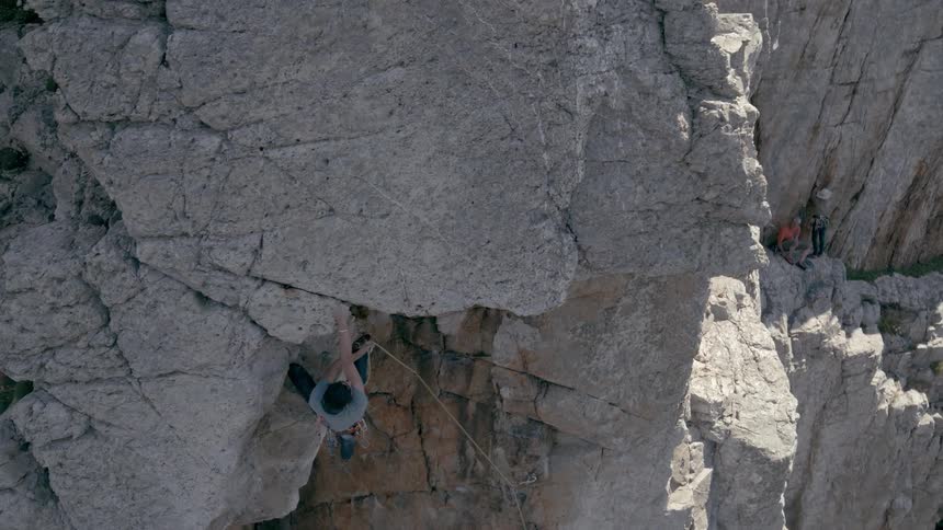 Man climbs a rock wall in the cliffs