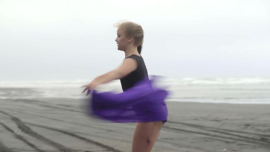 An elegant young artist expresses raw human emotion through movement by the powerful ocean.