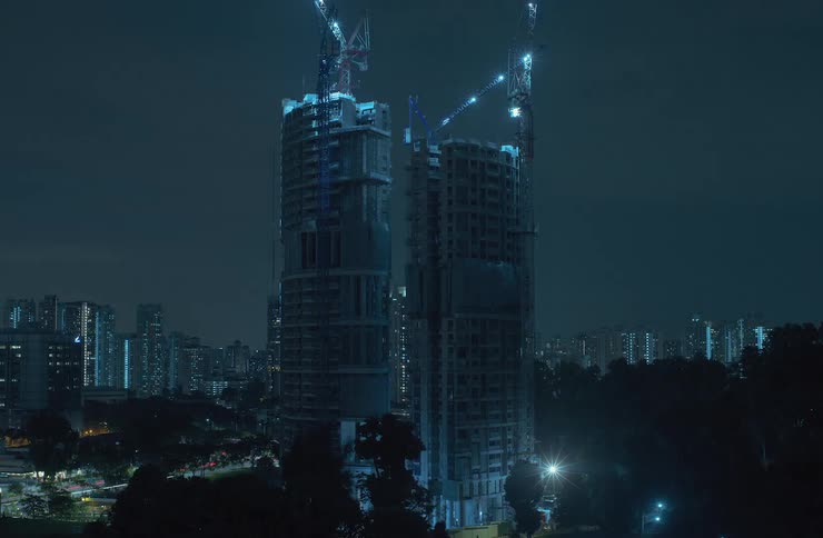 Twin skyscrapers get built floor by floor at night