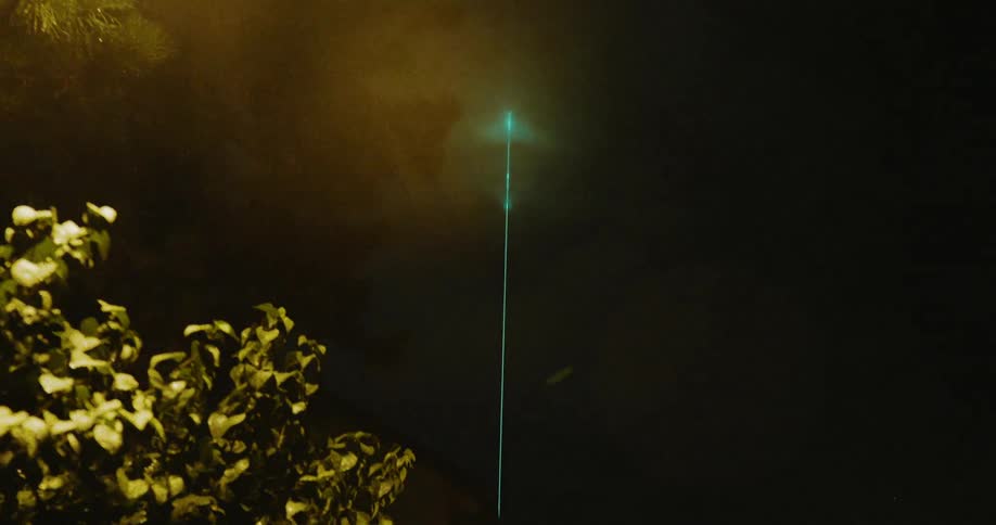 Bright green light on a tower at night