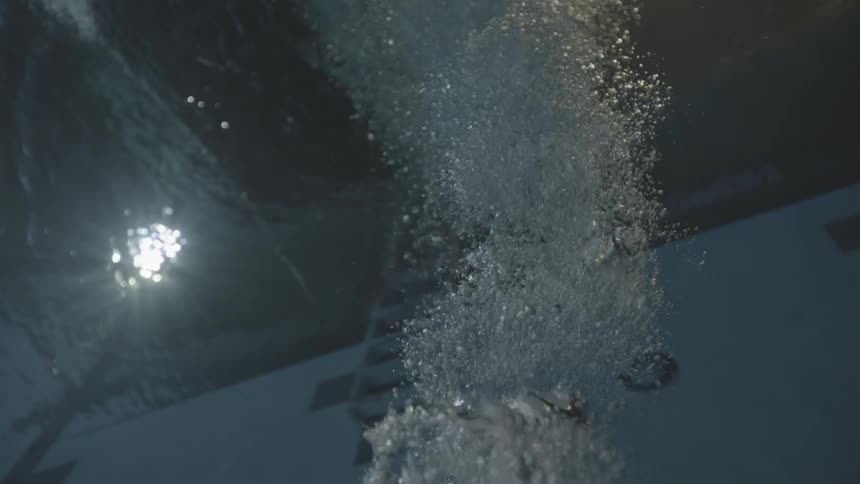 Bubbles rise from the bottom of a pool