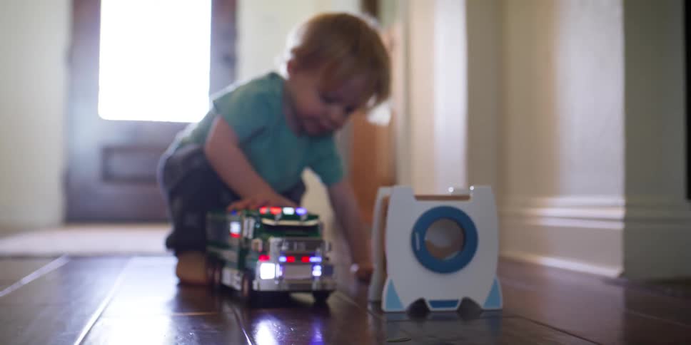 Boy playing with a toy truck at home