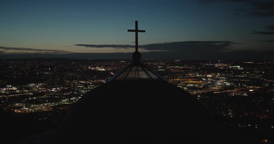 Aerial of a cross on the roof of a climate in the city