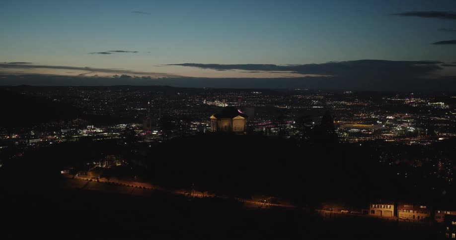 A large city lit up by many lights under the night sky