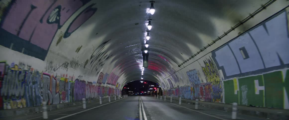 Interior of a tunnel with walls covered in graffiti