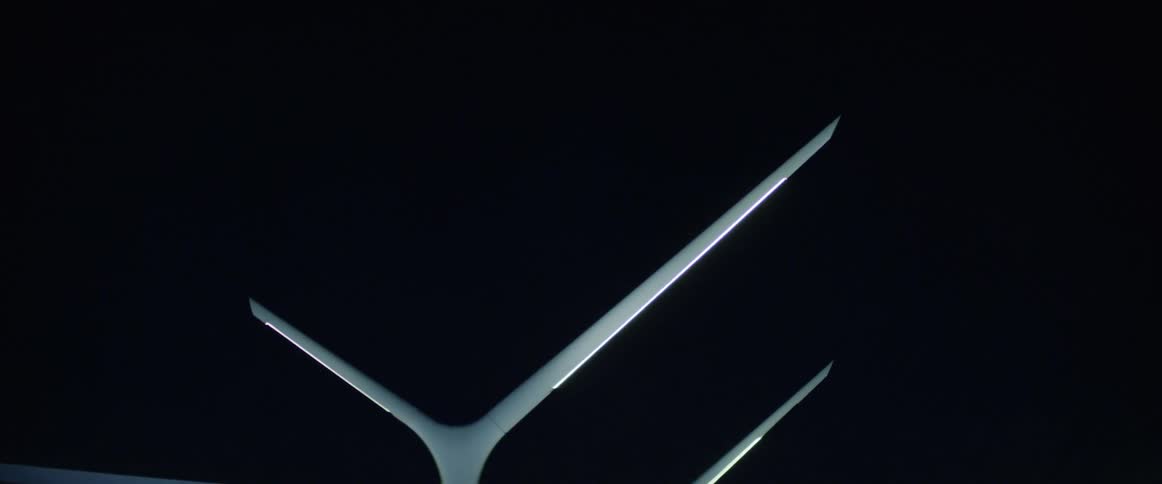 Three objects with sharp lines behind and the sky is all black