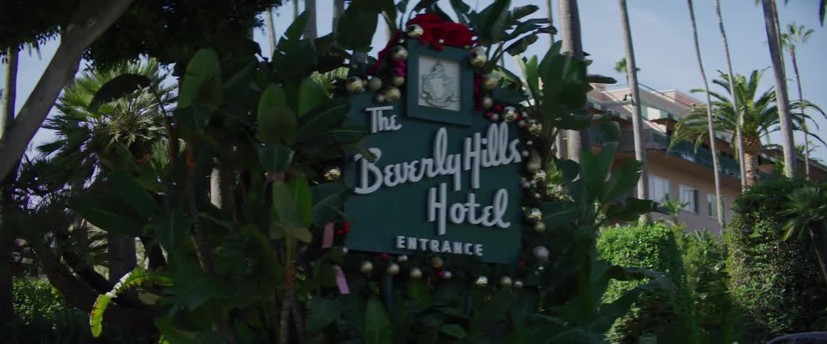A hotel surrounded by the citys plants and trees