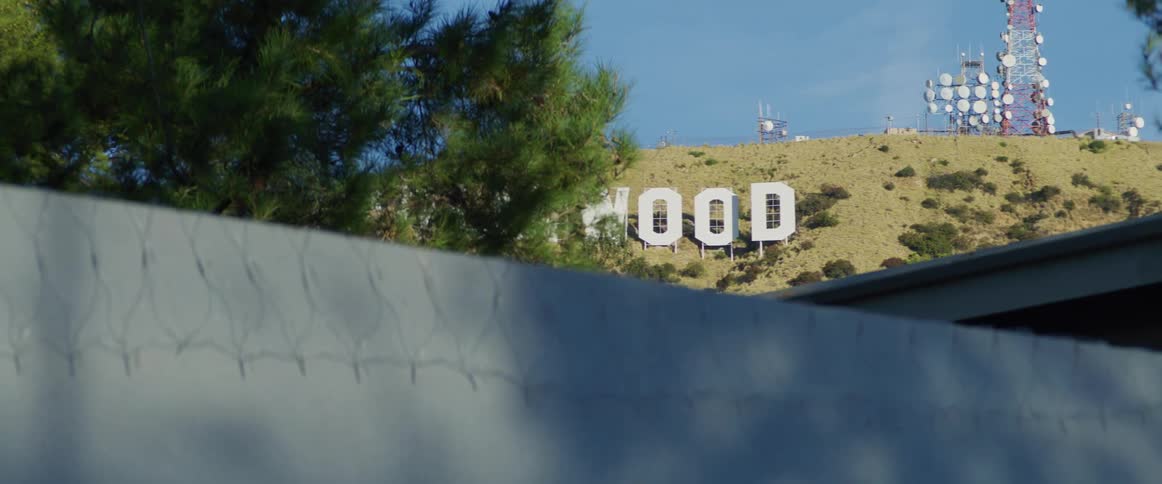 The hollywood sign is on the mountain
