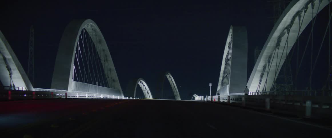 Traffic runs over the bridge at night