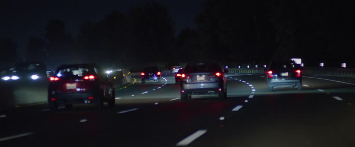Cars driving on the highway at night