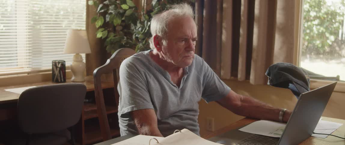 Confused elderly man working from home