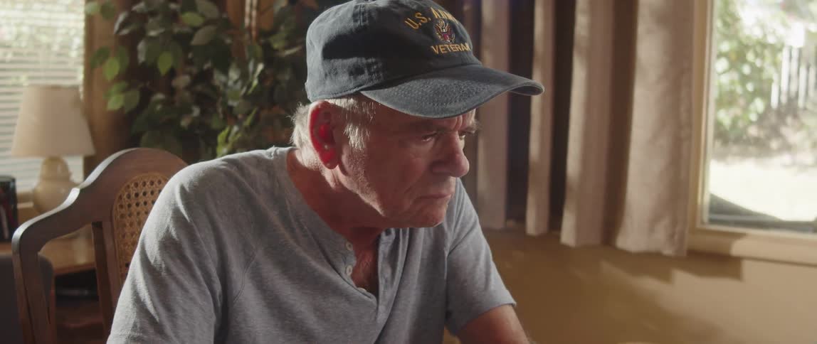 Elderly man gets focused while working at home