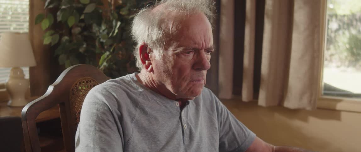 Confused elderly man sitting at home