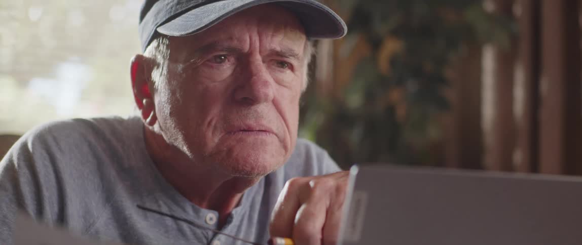 A sad man reading a document at home