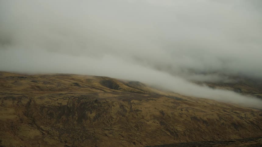 Aerial of the mountains covered by fog during the early hours of the morning