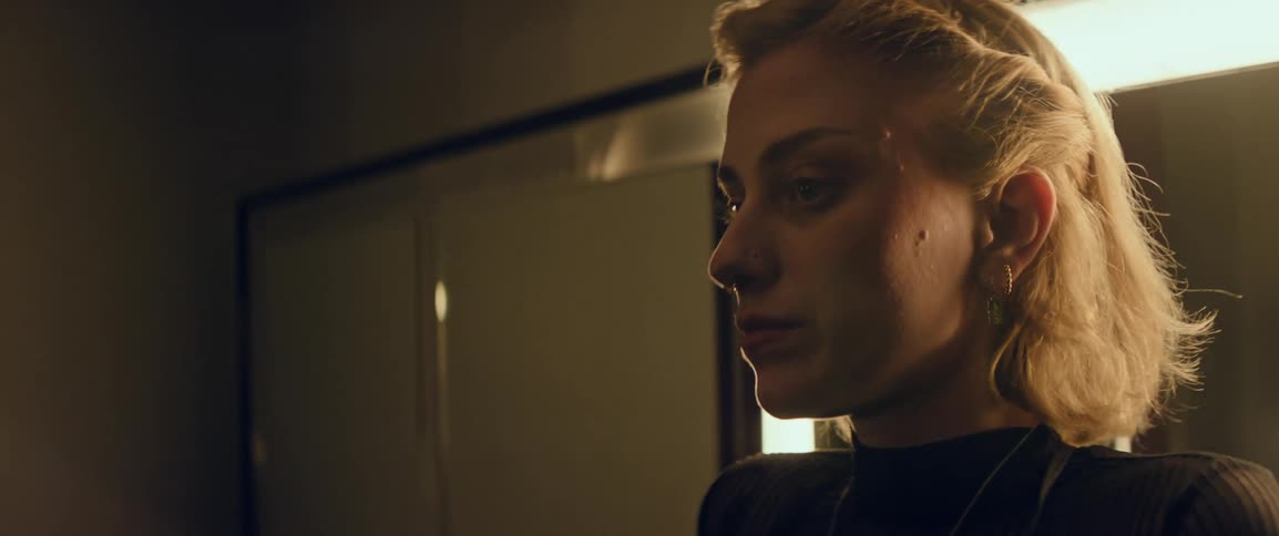 Blonde woman exits her dressing room