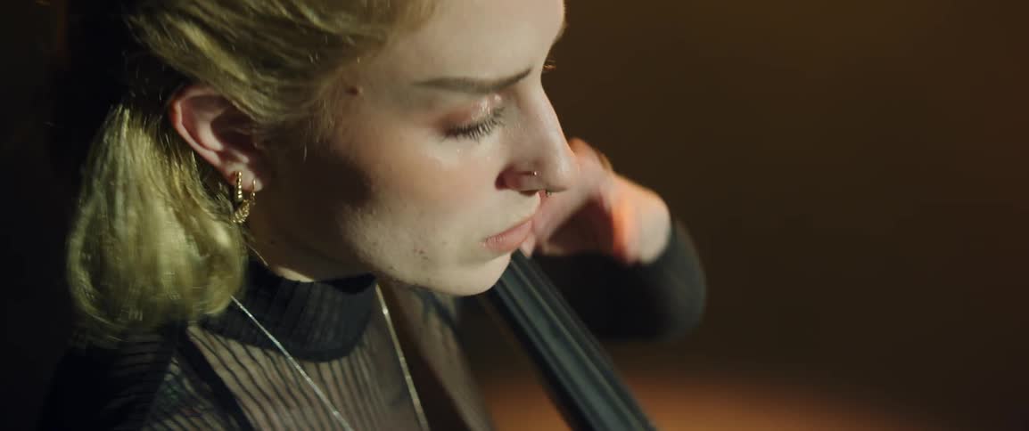 Inspired musician playing cello on stage