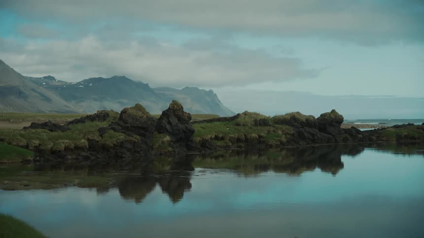 The coastline of a mountainous beach during sunset
