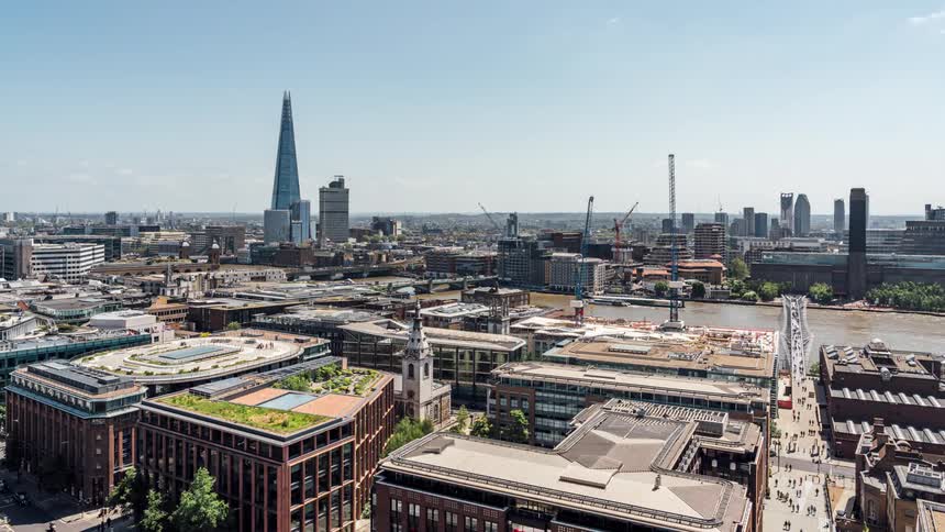 A busy city shows a time lapse of cars driving from high above