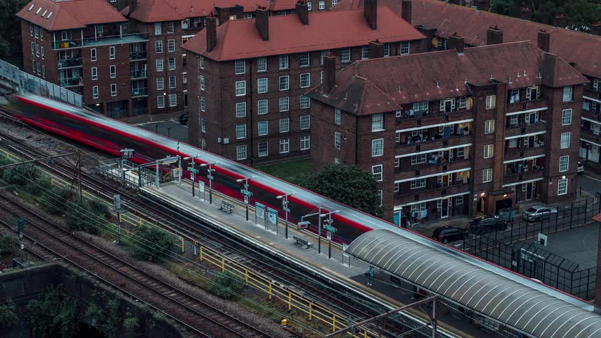 Aerial view of a waiting point with a train passing in timelapse