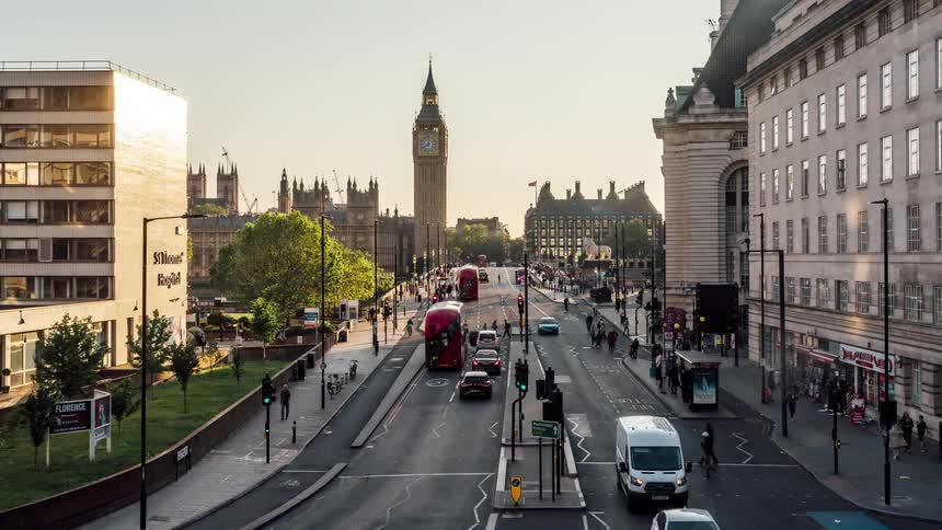 A busy street in london with the clock tower in a distance