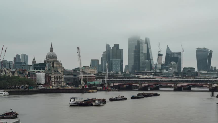 Panorama of a metropolis with skyscrapers facing the lake on a cloudy day
