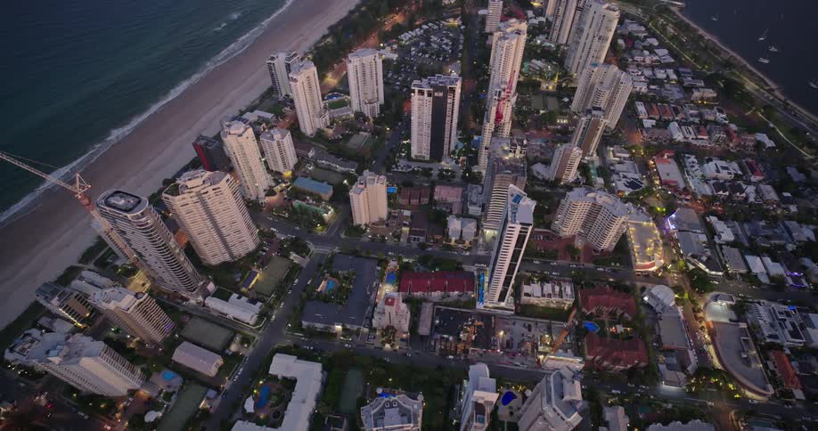 Aerial view of a modern waterfront city at sunset