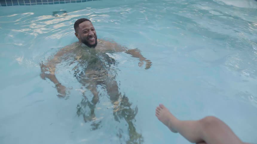 Couple swimming in swimming pool