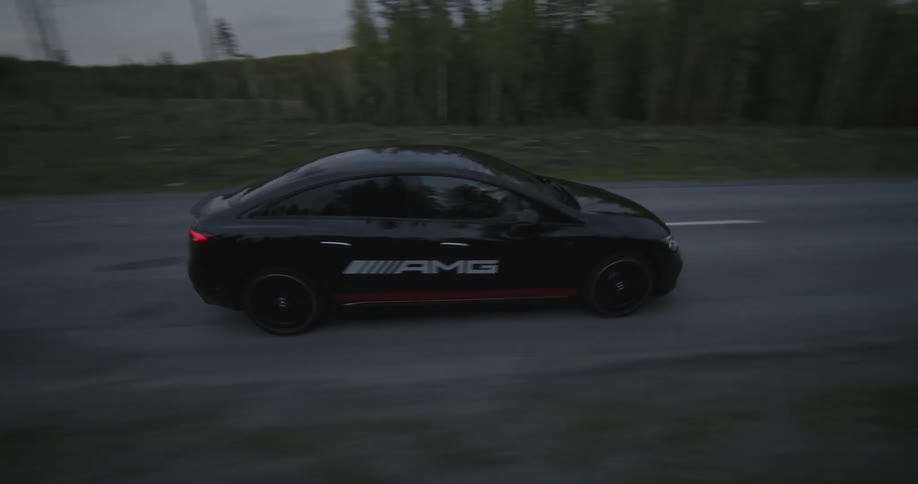 Aerial view of a car driving on a road through the countryside