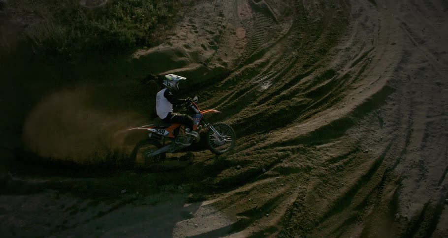 A person doing motocross is skidding the bike on the dirt