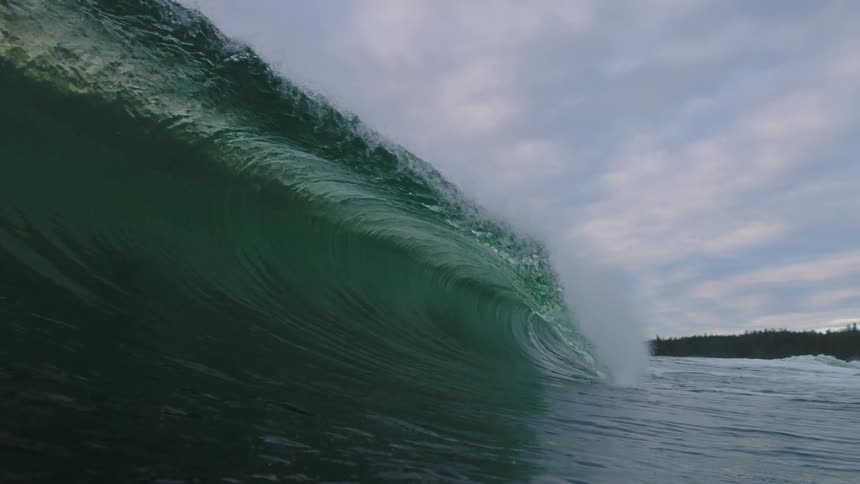 The large wave crashes below