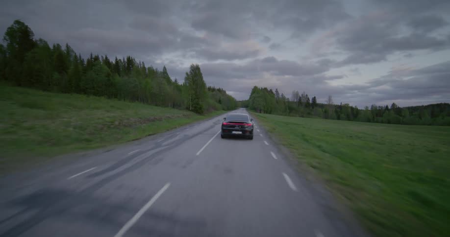 A car driving at high speed on a deserted road