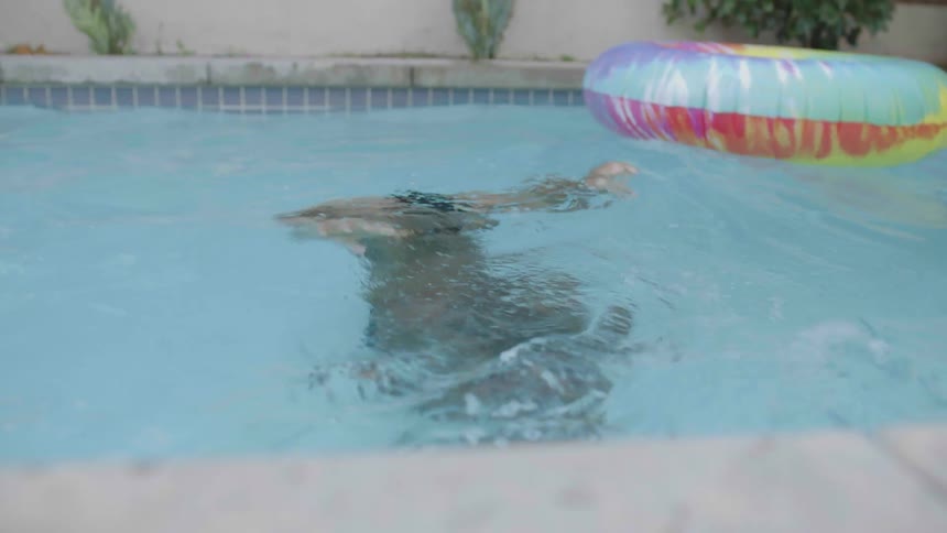 Man swimming and diving in the pool