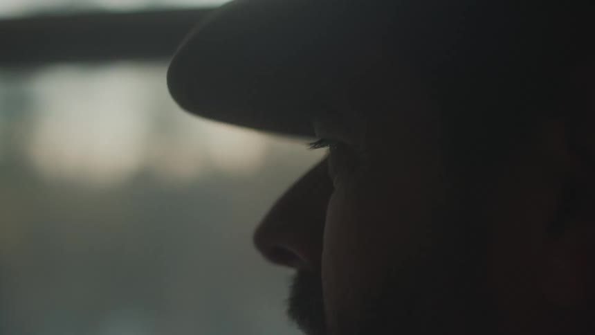 Side portrait of a man inside a moving vehicle