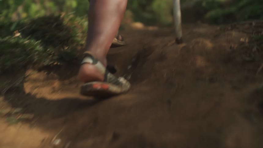 Closeup of the legs of a person walking on a trail