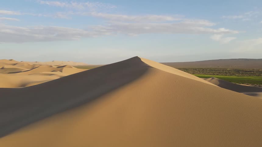 A large dune is in the desert