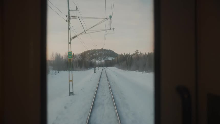 Train tracks in winter landscape pine trees mountain